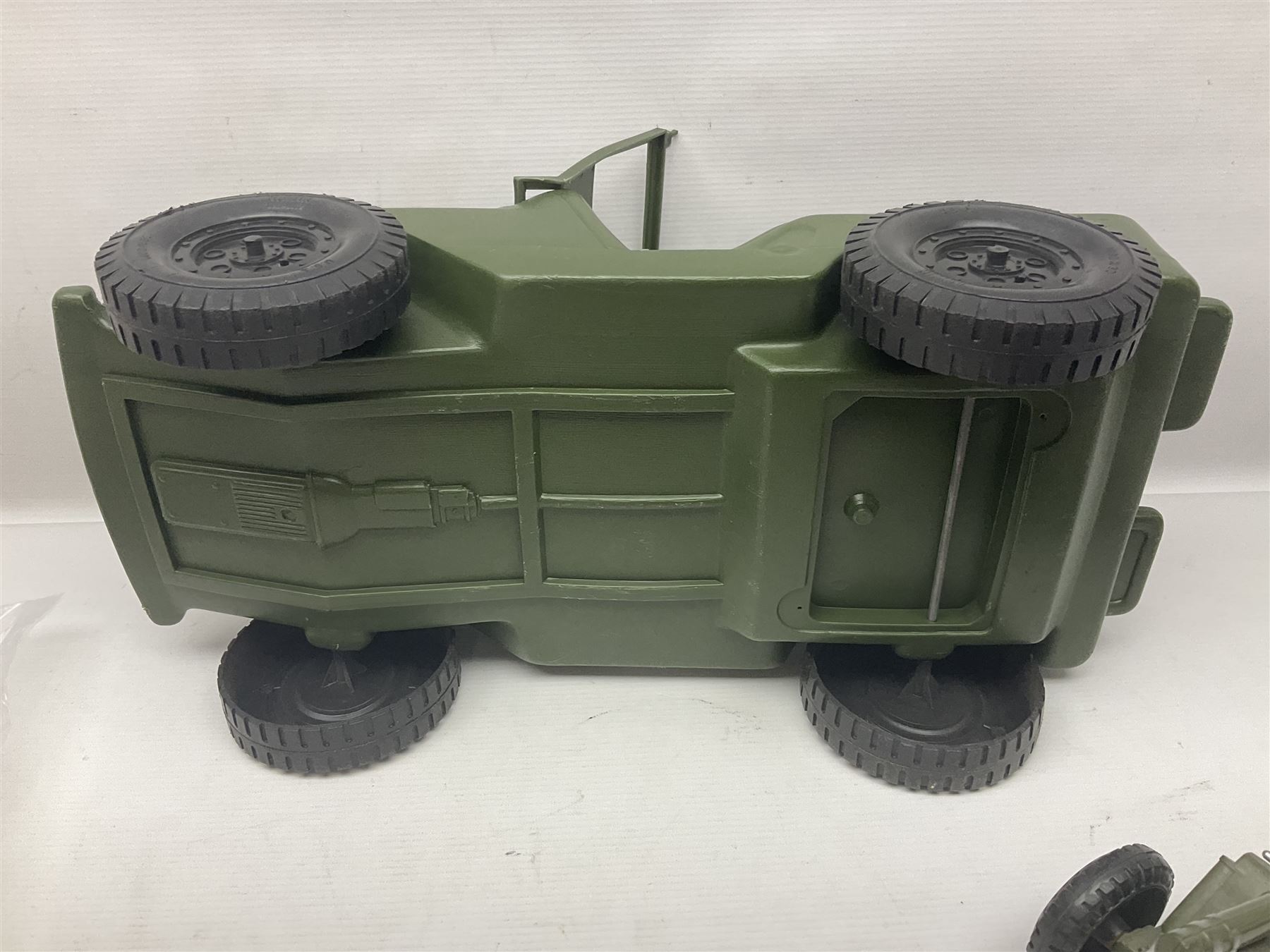 Action Man - five figures marked on the back 'Made in England by Palitoy under licence from Hasbro 1964', one dressed as a German Stormtrooper, one as a Red Devil Pilot and three in army uniform; another similar action figure marked to the right buttock ' G.I. Joe Copyright 1964 by Hasbro Patent Pending Made in Canada' dressed in army uniform; together with an Action Man jeep, field gun, mortar and machine guns and other accessories including helmets and weapons, parachute, diving equipment, skis and snow shoes, boots, uniforms etc; all unboxed