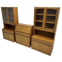 Sutcliffe of Todmorden - pair of teak wall units, fitted with two glazed doors over drawer and double cupboard (W86cm, D45cm, H198cm); and a matching fall front bureau (W84cm, D41cm, H100cm)