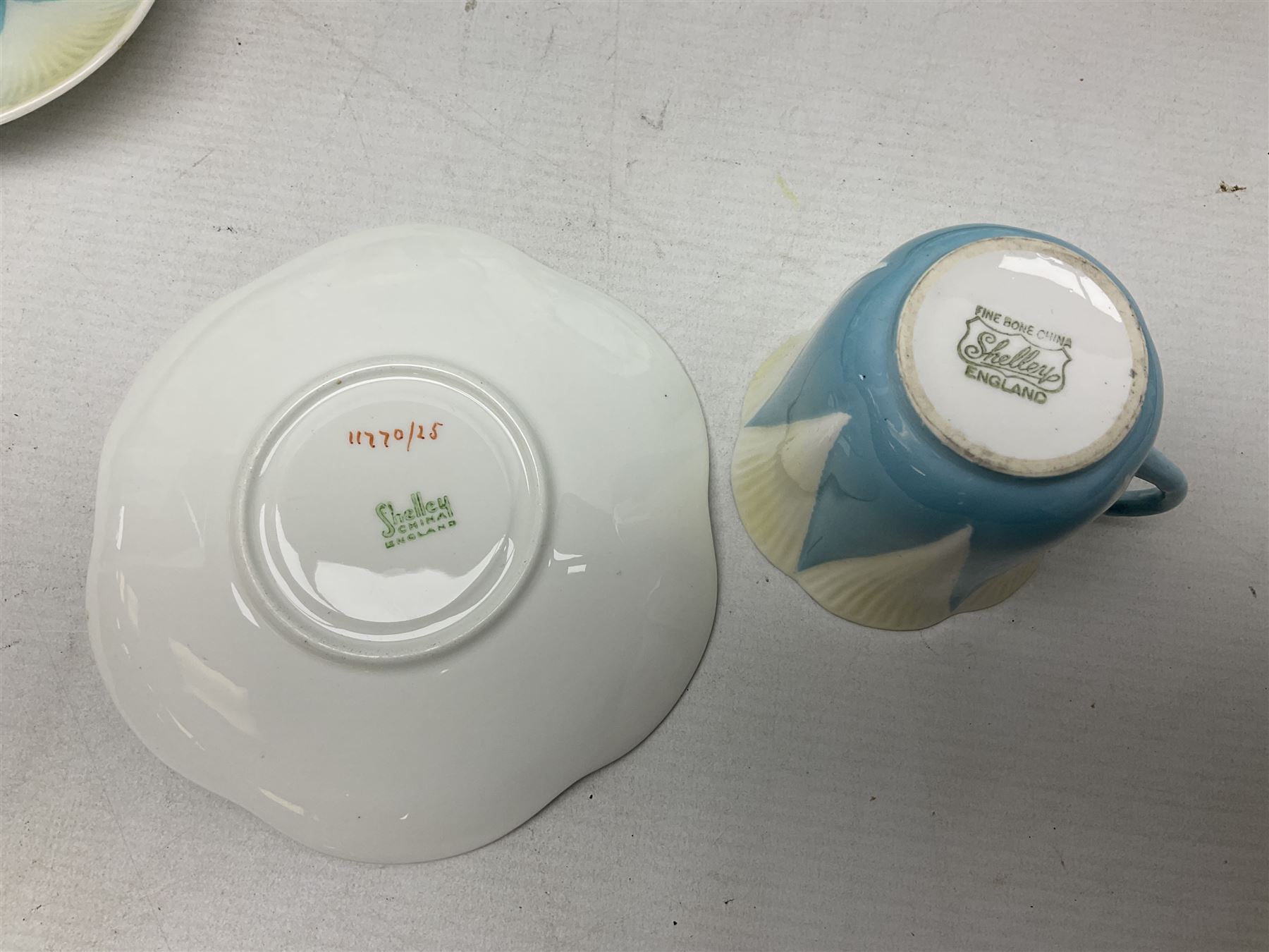 Shelley Dainty pattern tea wares, of lobed form with blue star decoration on merging white and yellow ground, comprising five teacups, five saucers, six tea plates, milk jug and cake plate, all with printed green mark beneath, some with painted pattern no 11770