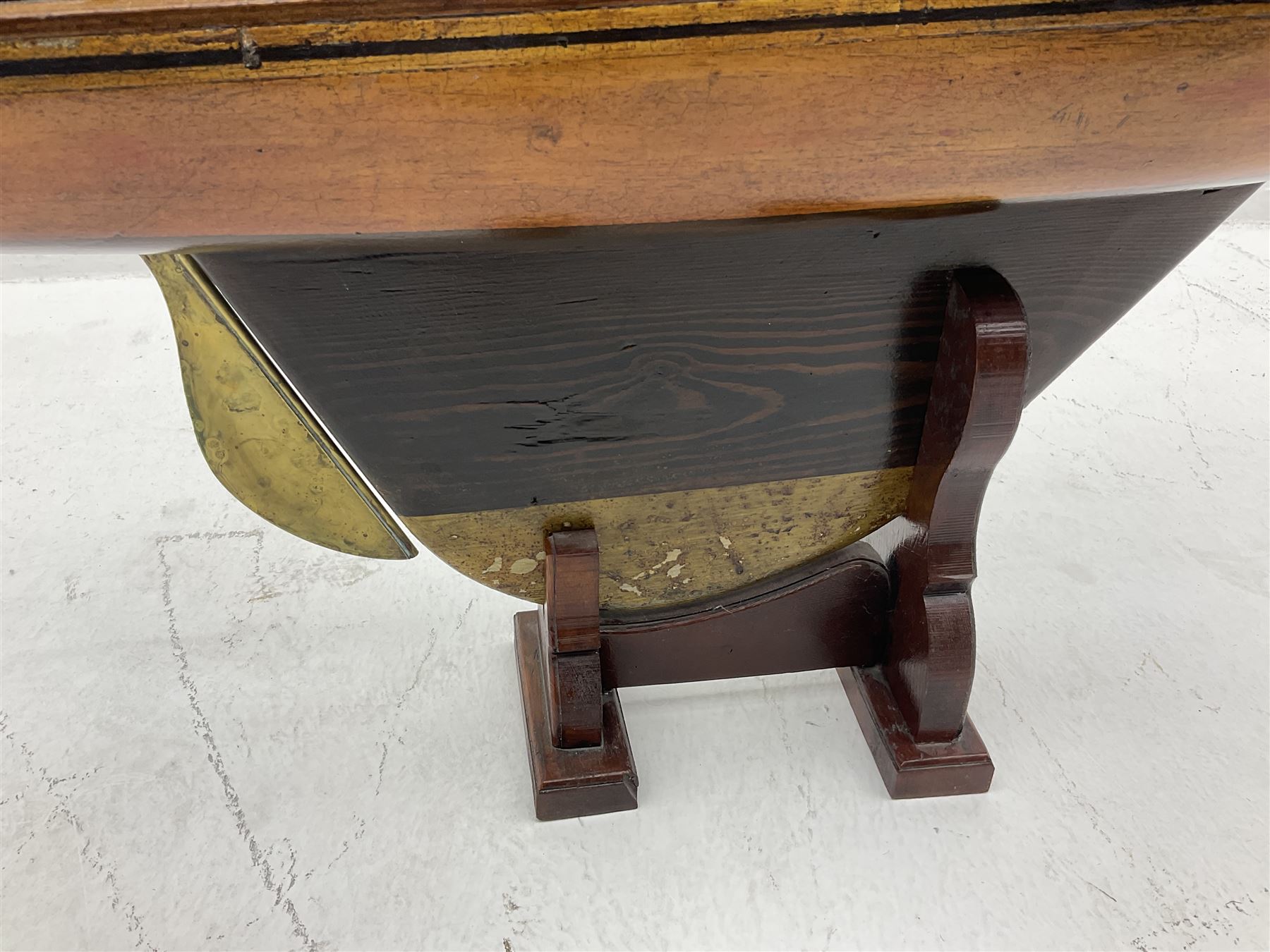 Early 20th century large pond yacht with mahogany hull, stained pine keel with brass rudder, simulated deck hatches and brass fittings, rigged as a staysail schooner (?) with four sails L117cm H148cm; loose mounted on stained pine stand