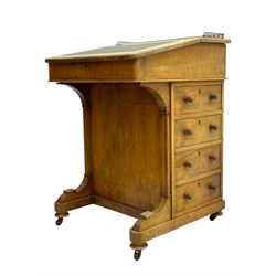 Early 19th century burr walnut Davenport desk, sloped leather-inset writing surface with brass gallery, fitted with an inkwell compartment and pen slot, four drawers to one side, raised on scrolled supports terminating in castors