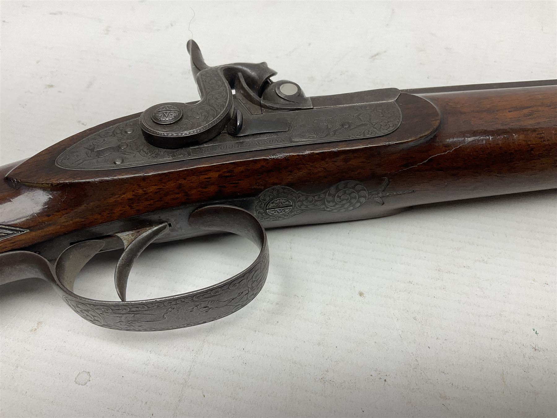 Mid-19th century percussion rifle by Geo. Forrest & Sons of Jedburgh No.844, 79cm octagonal barrel (approx .45 bore) with folding foresight, the lock plate with dolphin hammer finely engraved with a tiger and a stag, trigger guard engraved with hounds chasing a stag, figured walnut half stock with chequered grip and original ramrod 121cm overall; with framed photograph of original owner Dr. A.B. Dresser and archive of related ephemera including manuscript letter from the makers to Dr. Dresser regarding the sight specifications.