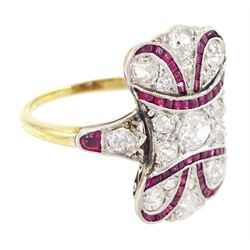 Early 20th century gold and platinum ruby and diamond panel ring, the principal old cut diamond of approx 0.30 carat, with old cut diamond surround and milgrain set calibre cut ruby ribbon motif, the tulip head shoulders set with a further diamond and ruby, total diamond weight approx 1.75 carat