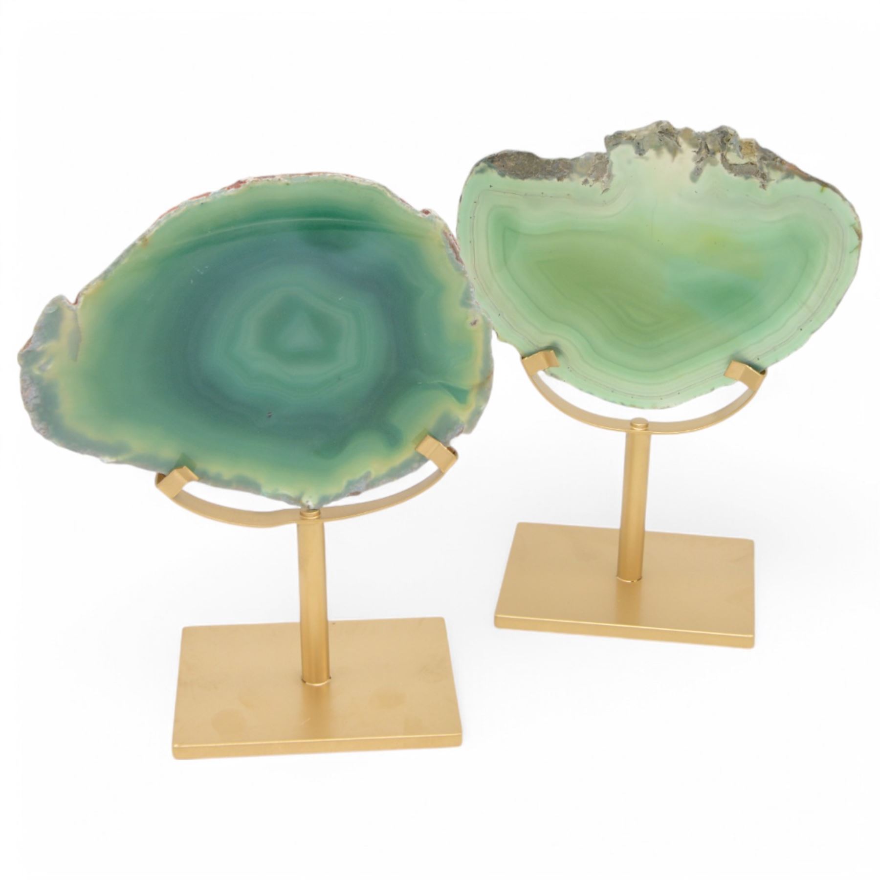 Pair of green agate slices, polished with rough edges raised upon gilt metal stands, H21cm