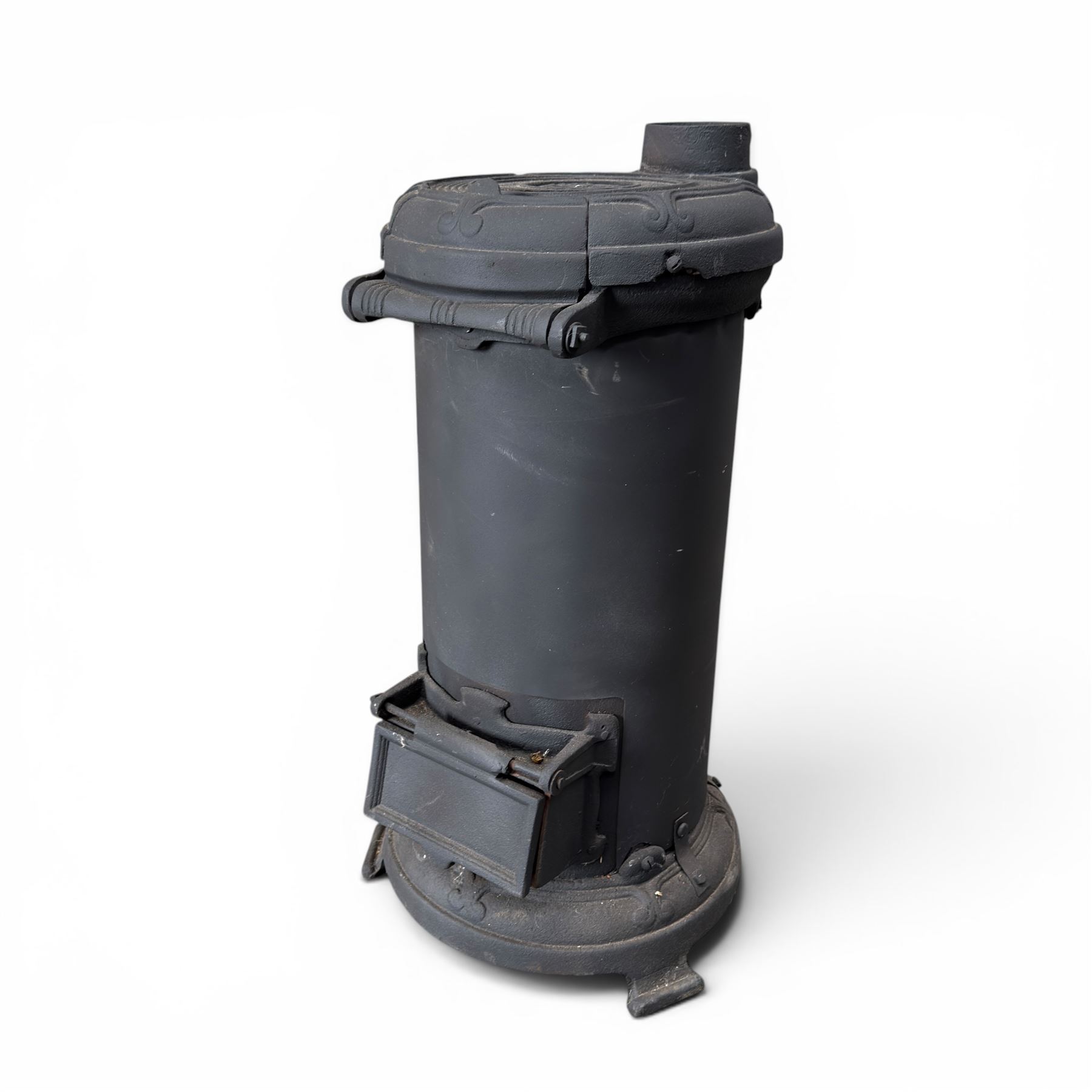 Late Victorian cast iron stove of small proportions, decorated with scrolls and central rosette to the top