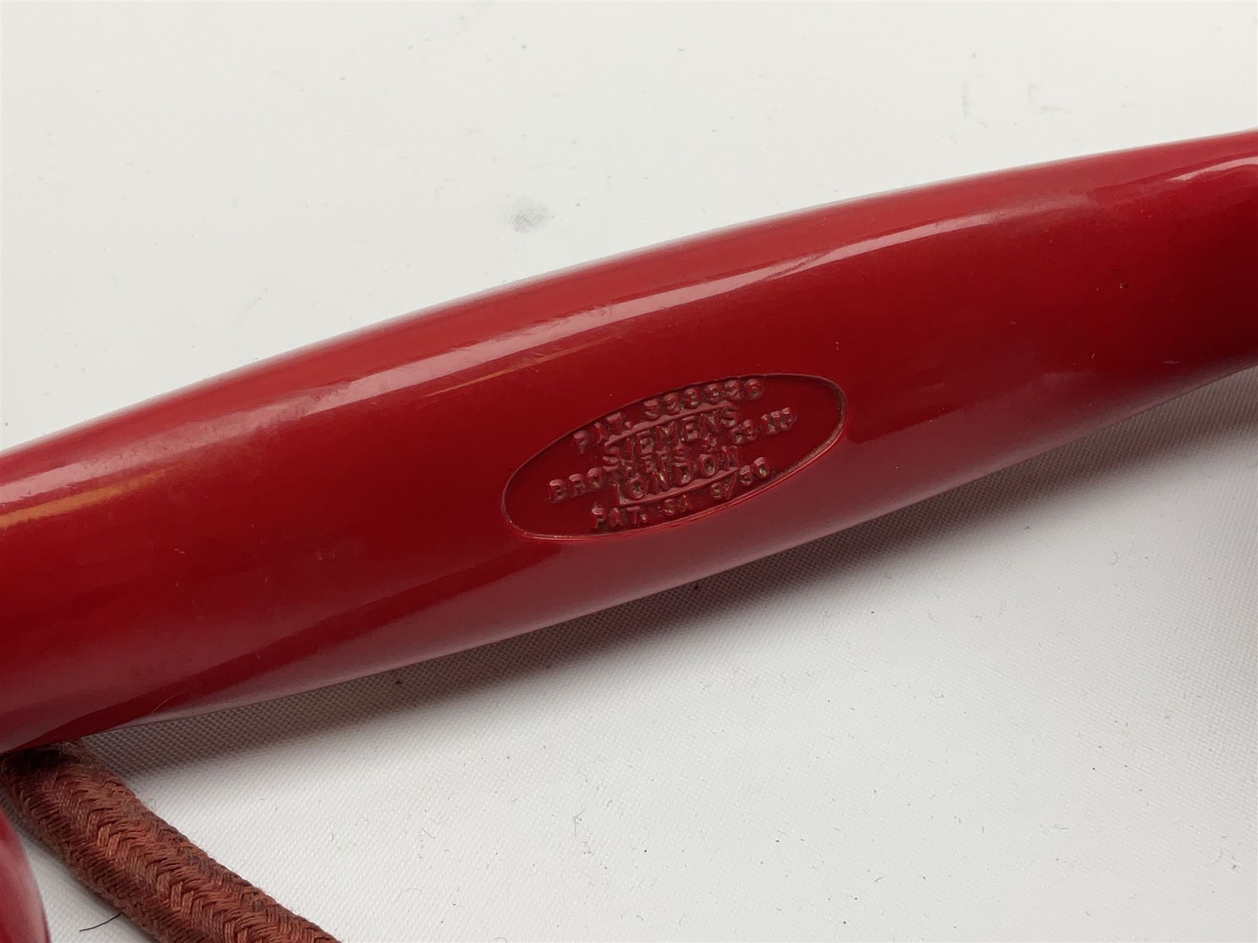 1950s Siemens Brothers red telephone with chrome rotary dial with enamel number plate and Siemens dial label, model 356, the body with base drawer below gilt logo, the handset with impressed mark PAT. 328926 PAT. SA 9/30, with red braided cord and red junction box (detatched), W15cm D18.5cm H14cm