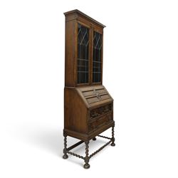 Early 20th century Jacobean Revival oak bureau-bookcase, astragal glazed doors enclosing two adjustable shelves, over geometric panelled fall-front enclosing fitted interior, over two drawers, raised on a spiral-turned base with barley-twist stretchers and compressed bun feet