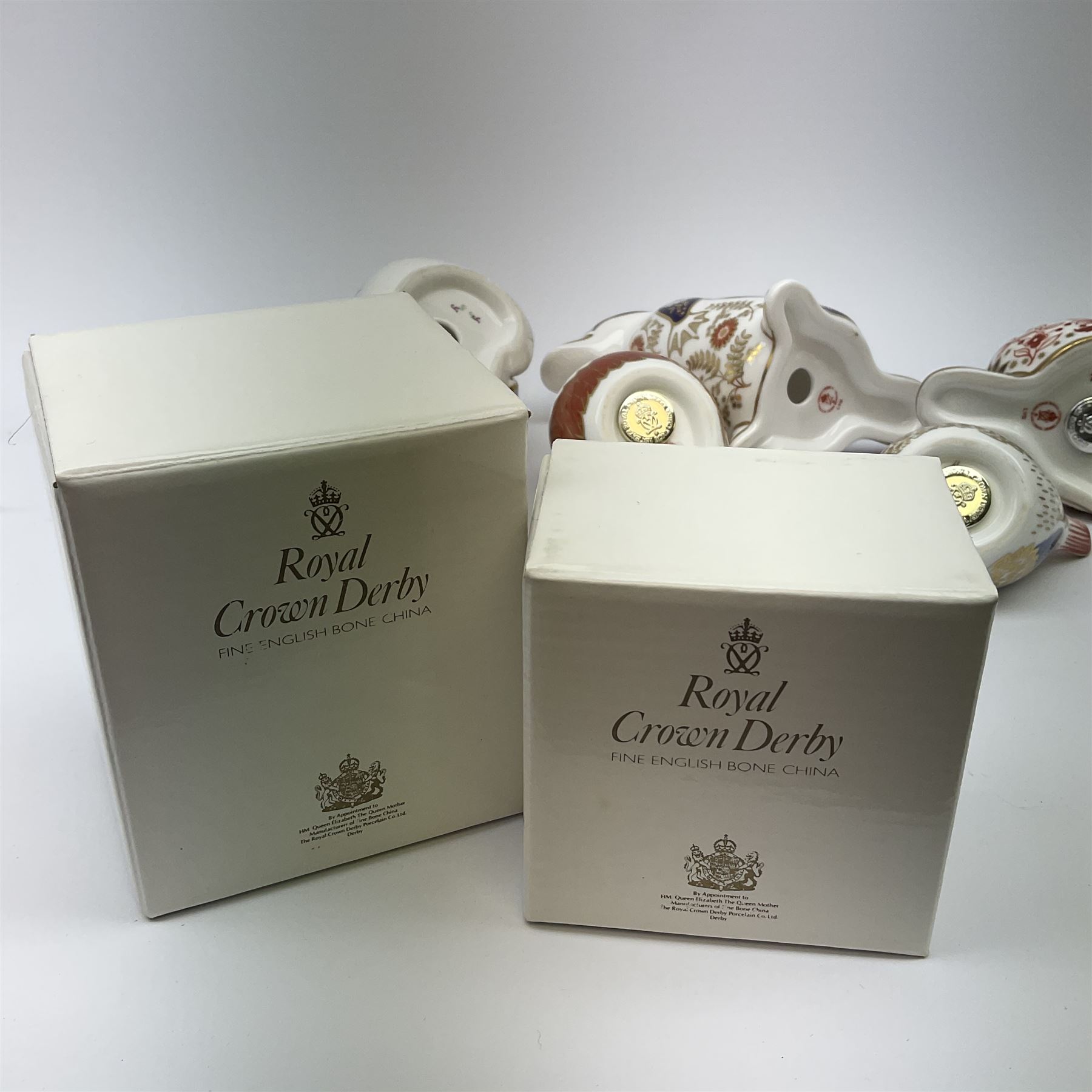 Five Royal Crown Derby paperweights, comprising Chaffinch, and Goldcrest, each with gold stopper, and box, example modelled as a Beaver with silver stopper, and two further examples lacking stoppers. 