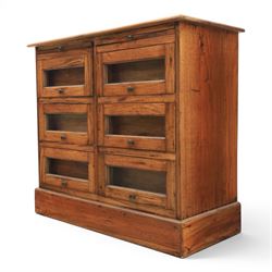 20th century Haberdashery style hardwood chest, two brushing slides, with six glass fronted drawers, blackened metal pulls, plinth base 