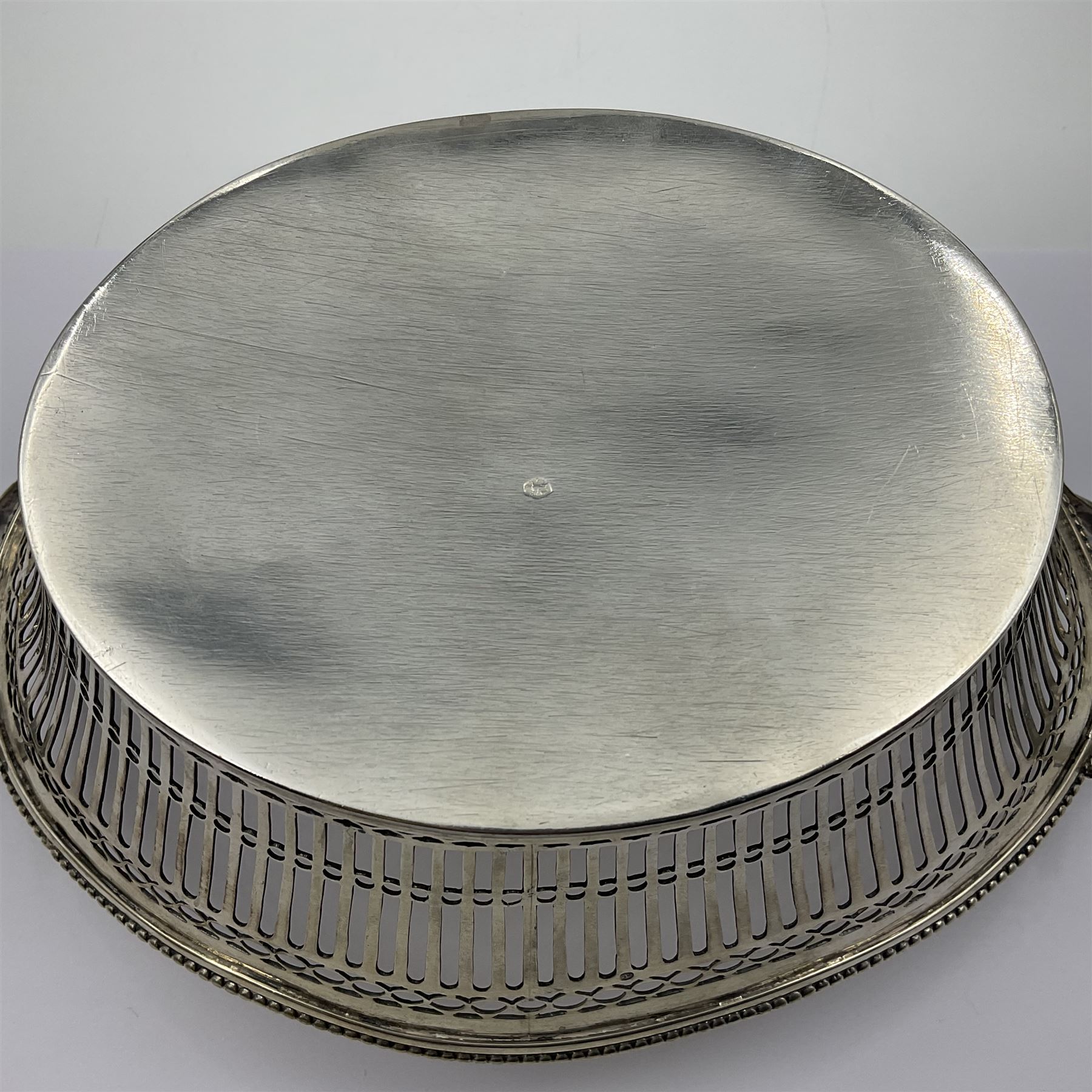Early 20th century Dutch silver basket, of oval form with pierced sides, beaded rim, and twin handles, marked with Lion Passant for 2nd standard purity and date letter for 1910, other marks worn and indistinct, including handles H8.5cm L25.5cm