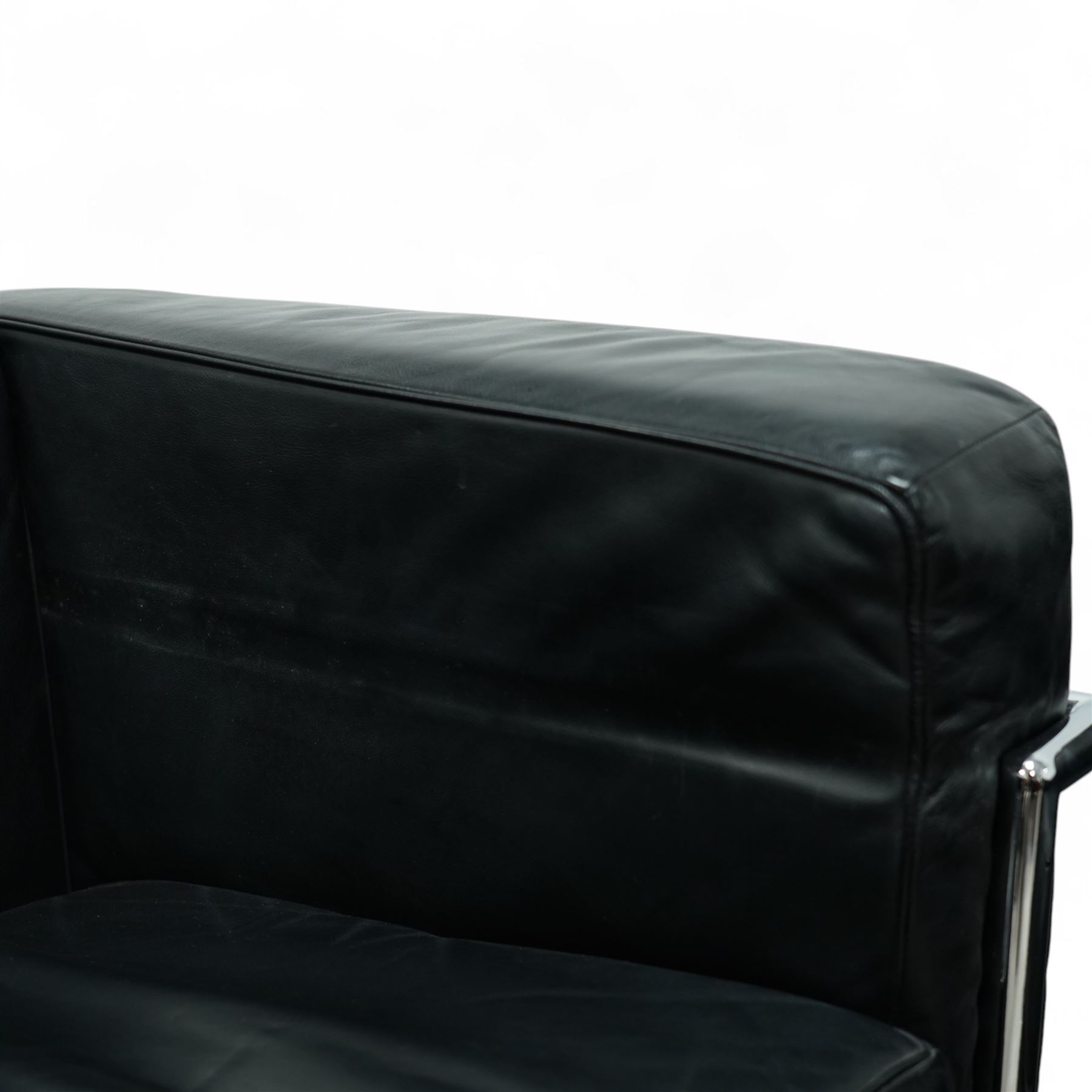 Contemporary pair of black leather chrome arm chairs of Le Corbusier LC2 inspired design, cube form with loose seat and back cushions enclosed in a tubular chrome frame and supports