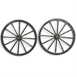 Pair of Victorian black lacquered and painted cartwheels with twelve spokes