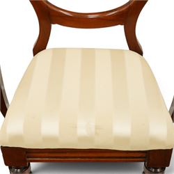 Set of twelve Victorian walnut balloon-back dining chairs, shaped open back over seats upholstered in striped ivory fabric, moulded seat rail above turned and tapering suppors