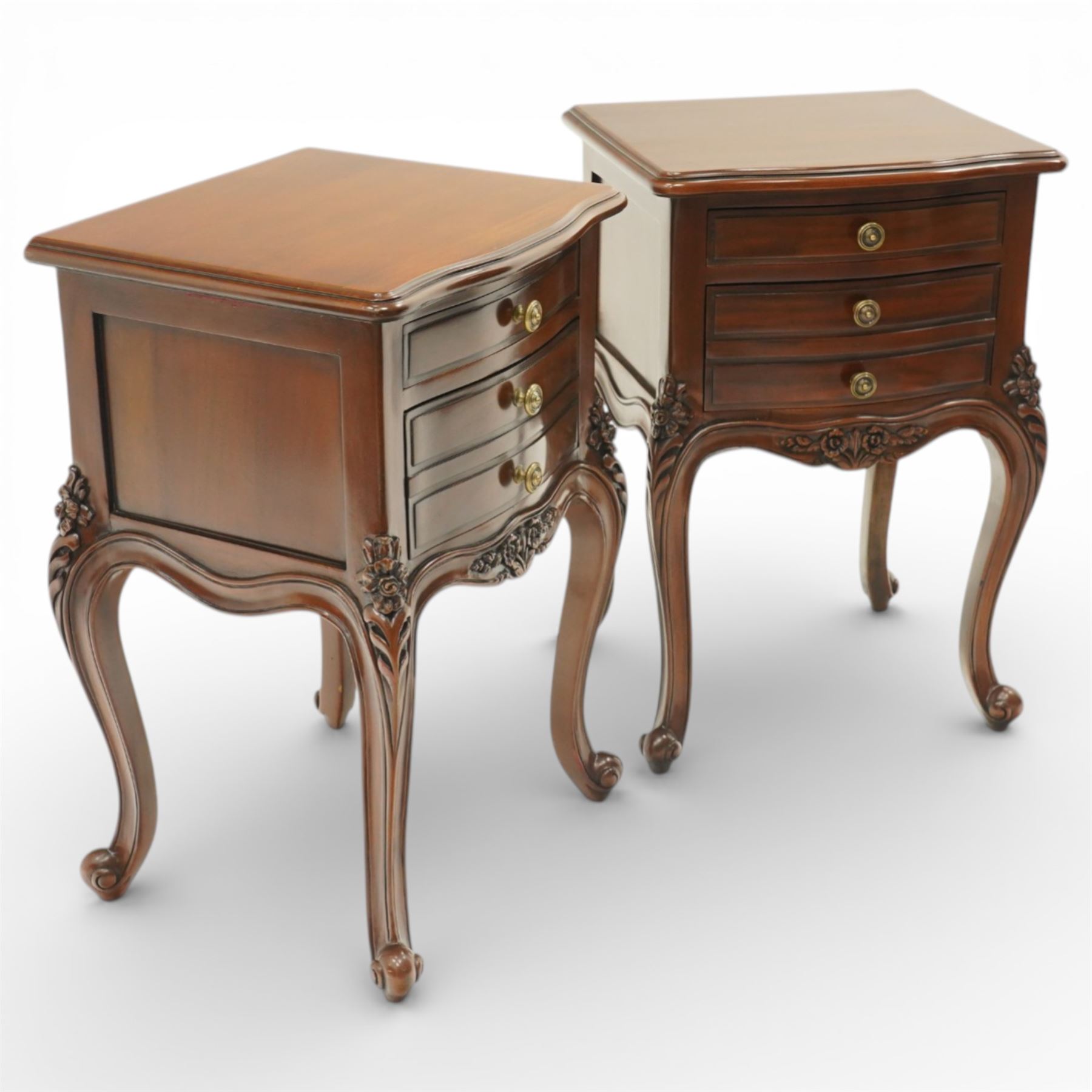 Pair of French Rococo design bedside chests, with serpentine fronts, two drawers, brass handles and carved floral decoration, raised on cabriole legs with scroll feet