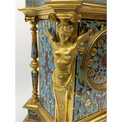 19th century French ormolu and champlevé enamel mantel clock, the twin handled urn with fruit and flower cast finial on cushion top, each corner set with urn, the front canted corners decorated with winged caryatid figures, turquoise ground champlevé work with scrolling floral pattern, twin train movement striking on bell by Japy Freres