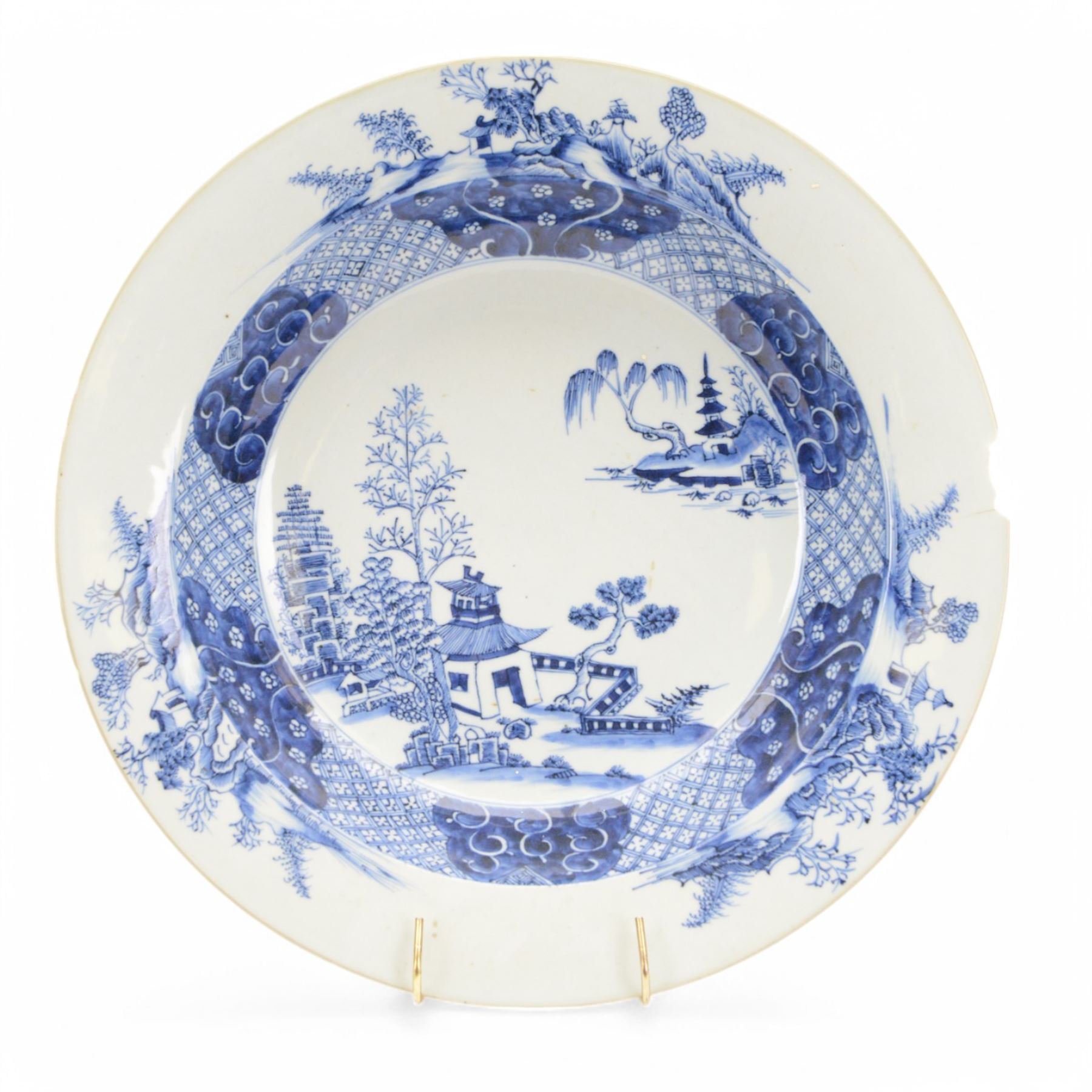 Large 19th century Chinese export blue and white bowl, of circular form, the dished centre decorated with pagodas, fence, and pine and willow trees, within a cell border with flower head and scroll detailed shaped reserves, the rim with conforming decoration of huts and trees, D39.5cm