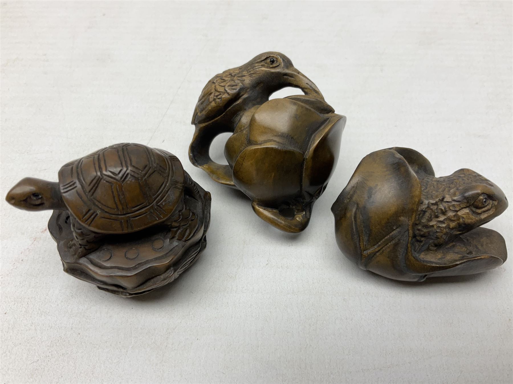 Six netsuke, modelled as a lizard, cricket, frog, bird on a flower, turtle and insect