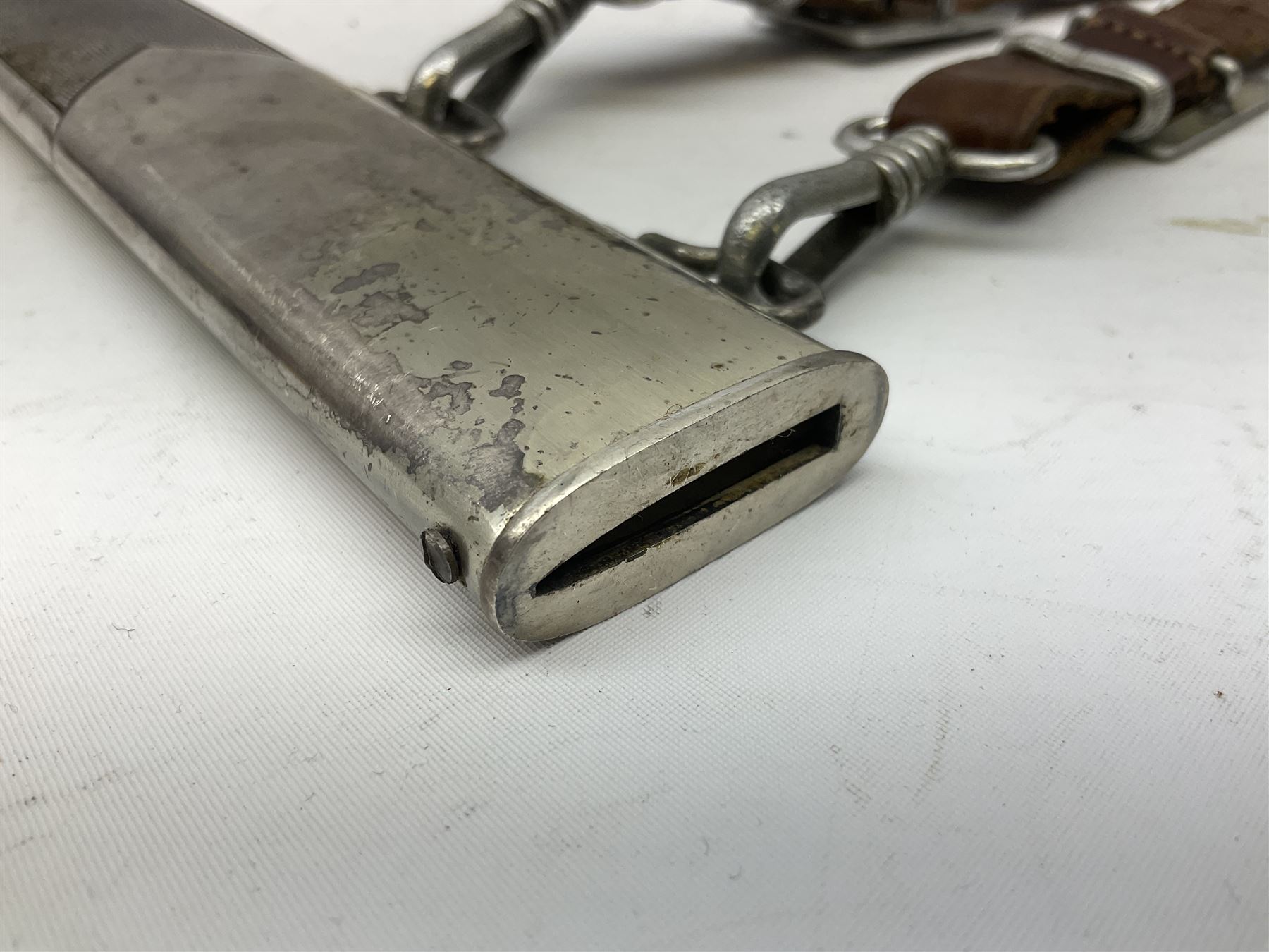 German Reichsarbeitdienst RAD Leader's Hewer dagger, the 26cm single edged scimitar shaped blade with narrow fuller, etched Arbeit adelt; by E.D. Wusthof, Solingen; the aluminium hilt with spade and wheat ear langet; two piece white plastic grip and eagle head pommel; pebbled steel scabbard engraved with ears of wheat and strapwork with double leather hangers L40cm overall