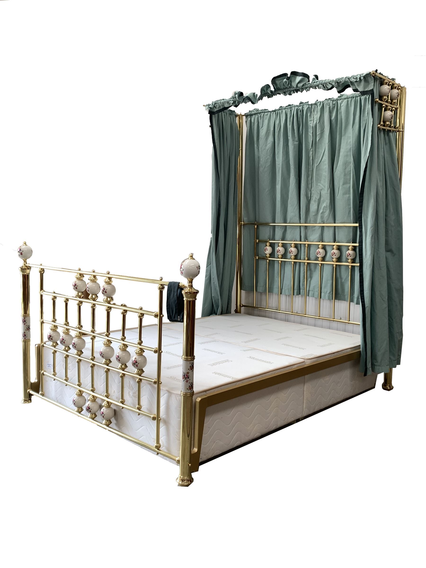 Victorian style brass 4’ 6” double half tester bed with porcelain finials, drapes and covers, fitted with divan base
