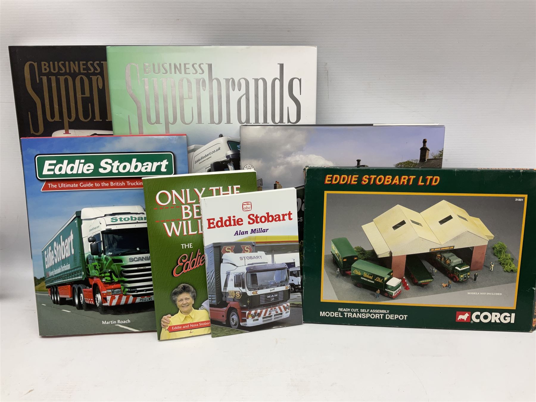 Eddie Stobart - accessories, memorabilia and promotional merchandise including Corgi Self Assembly Model Transport Depot and Five Figures Set; scarf; slippers; mugs and beakers; coasters; note book; books etc