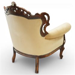 Late 19th century style carved hardwood armchair, the openwork crest rail with scrolling and foliate ornament, upholstered back and outscrolled arms with buttoning, loose seat cushion, nailhead trim, on carved cabriole legs