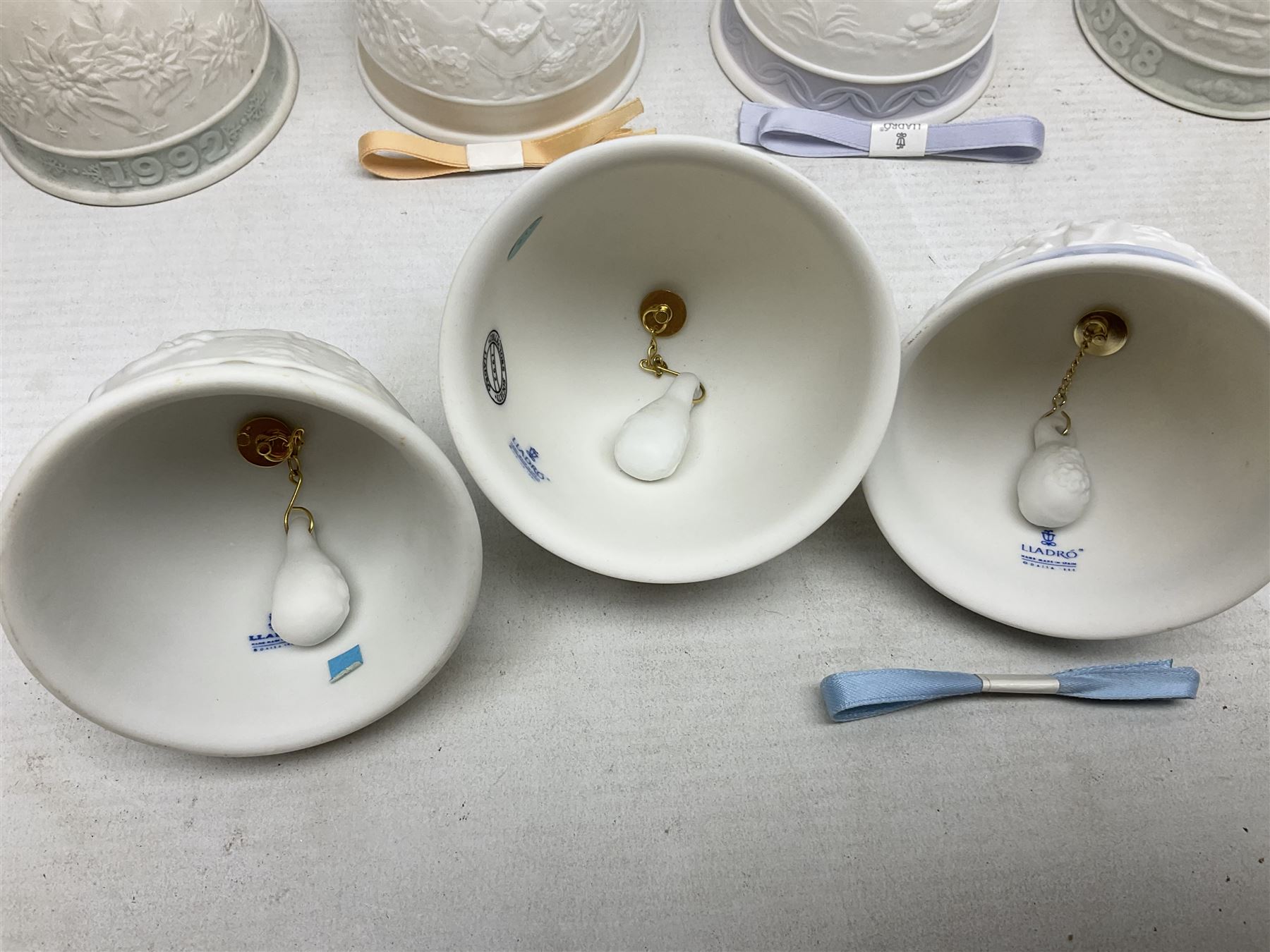 Seven Lladro bells, comprising Summer no 17614, Fall 17615, Christmas 1988 no 5525, Christmas 1989 no 5616,  Christmas 1990 no 5641, Christmas 1992 no 15913 and Christmas 1993 no 16010, together with two Lladro Christmas balls no 1603 and Lladro easter eggs 1994 no 17532