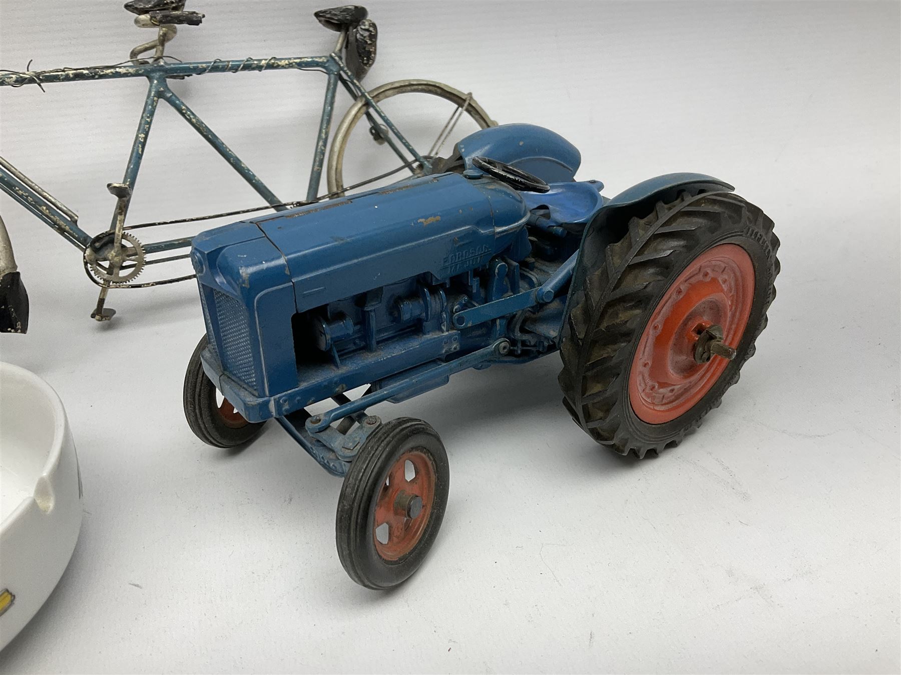 Chad Valley clockwork Fordson Major Tractor, a group of play worn Britains and other lead and metal farm animals, figures and accessories including a kennel, haystacks, dovecote, cows, sheep etc, together with a diecast model of a Tandem Bike L31cm