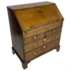 George III oak bureau, the fall front with rest enclosing pigeonholes, drawers and slide revealing storage well, fitted with two short and two long drawers, shaped brass handle plates and ring handles 