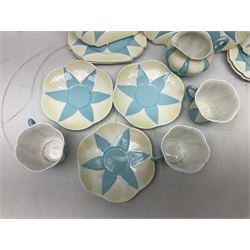 Shelley Dainty pattern tea wares, of lobed form with blue star decoration on merging white and yellow ground, comprising five teacups, five saucers, six tea plates, milk jug and cake plate, all with printed green mark beneath, some with painted pattern no 11770