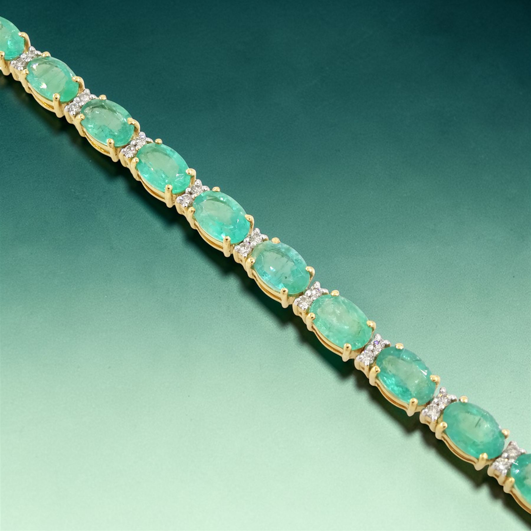 18ct gold emerald and diamond bracelet, twenty-seven oval cut emeralds, each spaced by two round brilliant cut diamonds, stamped 18K, total emerald weight approx 12.35 carat, total diamond weight approx 0.50 carat