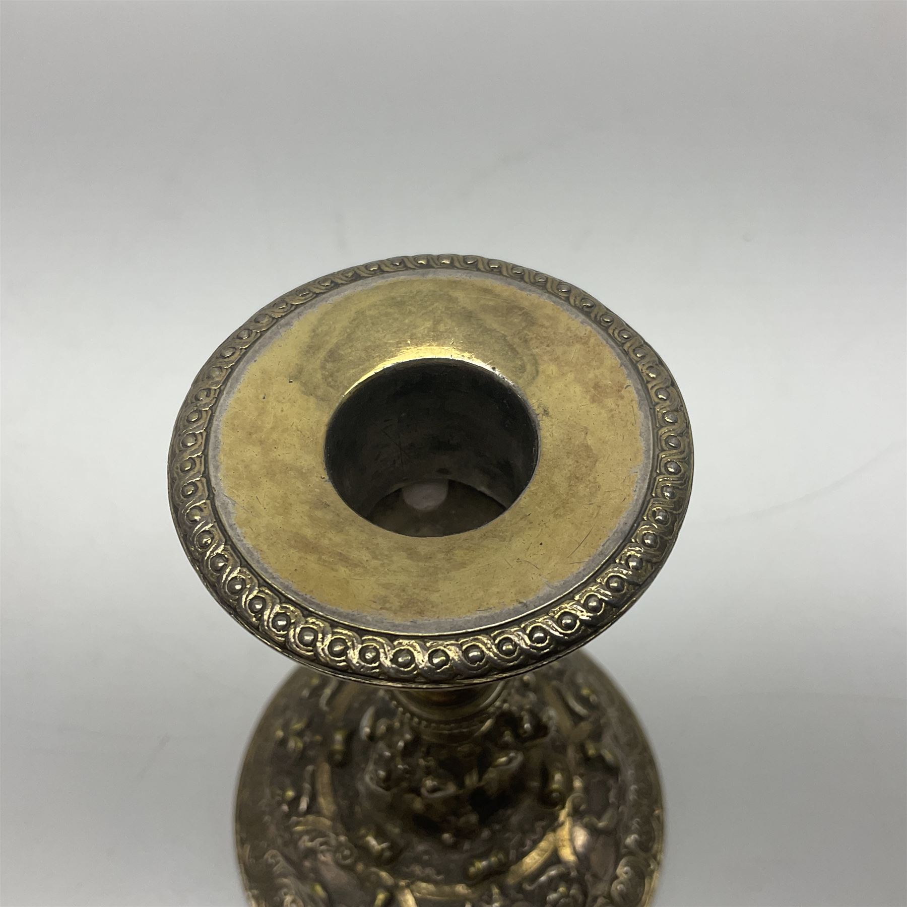 Pair of Victorian Elkington Mason & Co silver plated candlesticks, decorated in relief with ram masks and figures, H14cm