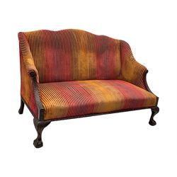 Mid-19th century mahogany two-seat sofa, upholstered in striped velvet fabric, the shaped backrest leading to outward-curved arms, carved apron with scrolling foliate details, raised on cabriole supports terminating in claw and ball feet