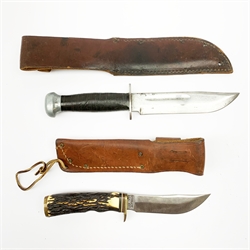 WW2 US Navy/US Marines RH PAL 36 fighting knife with aluminium top pommel marked 1944 and leather bound grip, 15cm blade, leather sheath marked 'WD BO RANDALL'; and US Schrade 497 fixed blade hunting knife with 11.5cm blade and simulated antler grip, in leather sheath (2)