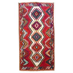 Persian Qashqai crimson ground rug, the central narrow ivory field decorated with repeatin...