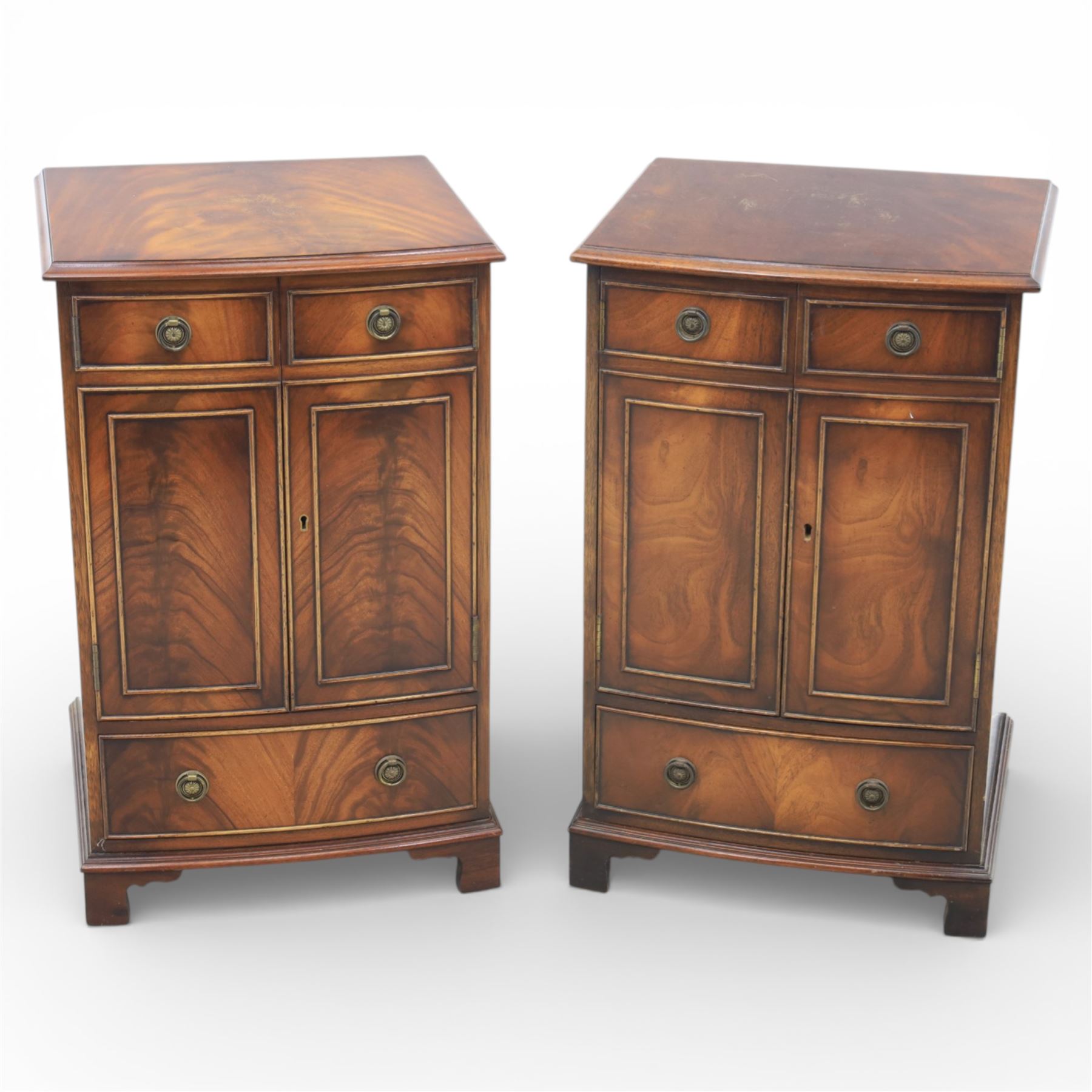 Reprodux - Georgian design pair of mahogany bow-front cabinets, moulded lifting hinged top, above a locking cabinet with drawer below, raised on bracket feet 