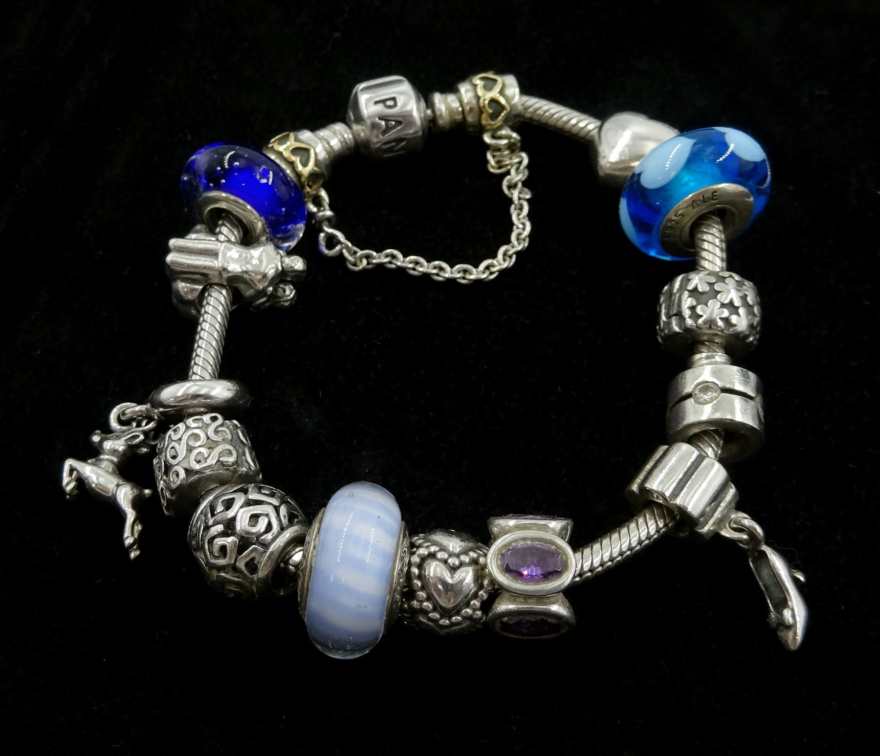 Collection of silver Pandora jewellery comprising a bracelet with thirteen Pandora charms and safety chain, necklace with one Pandora charm, and one stone set ring, in Pandora box