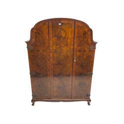 Early to mid-20th century burr walnut triple wardrobe, the crossbanded and bookmatched veneer doors enclosing hanging rail and shelves, on cabriole feet