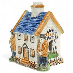 Yorkshire Prattware cottage, circa. 1820, in shades of blue, ochre and white, moulded in relief with two flanking gentlemen figures, H12cm 