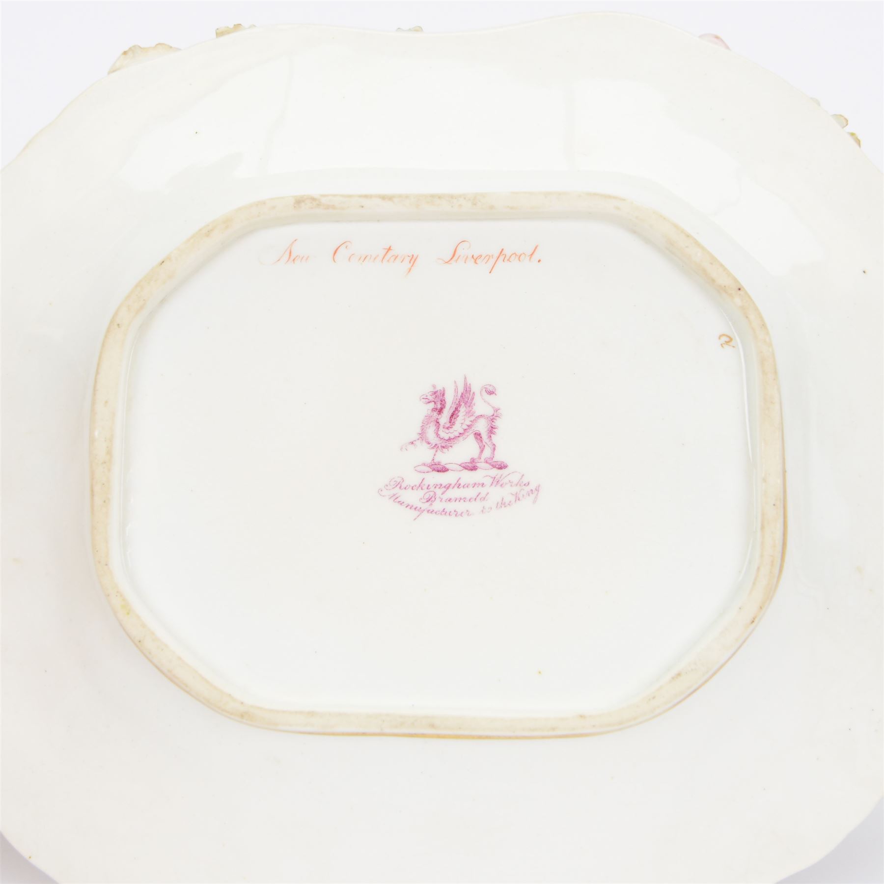 Early 19th century Rockingham porcelain basket, circa 1830, of elongated octagonal shape with gilt entwined, encrusted handle, the centre painted with a view of 'New Cemetery Liverpool', the rim encrusted and moulded with flowers and leaves, with puce Griffin mark and titled beneath, including handle H10.5cm W23cm