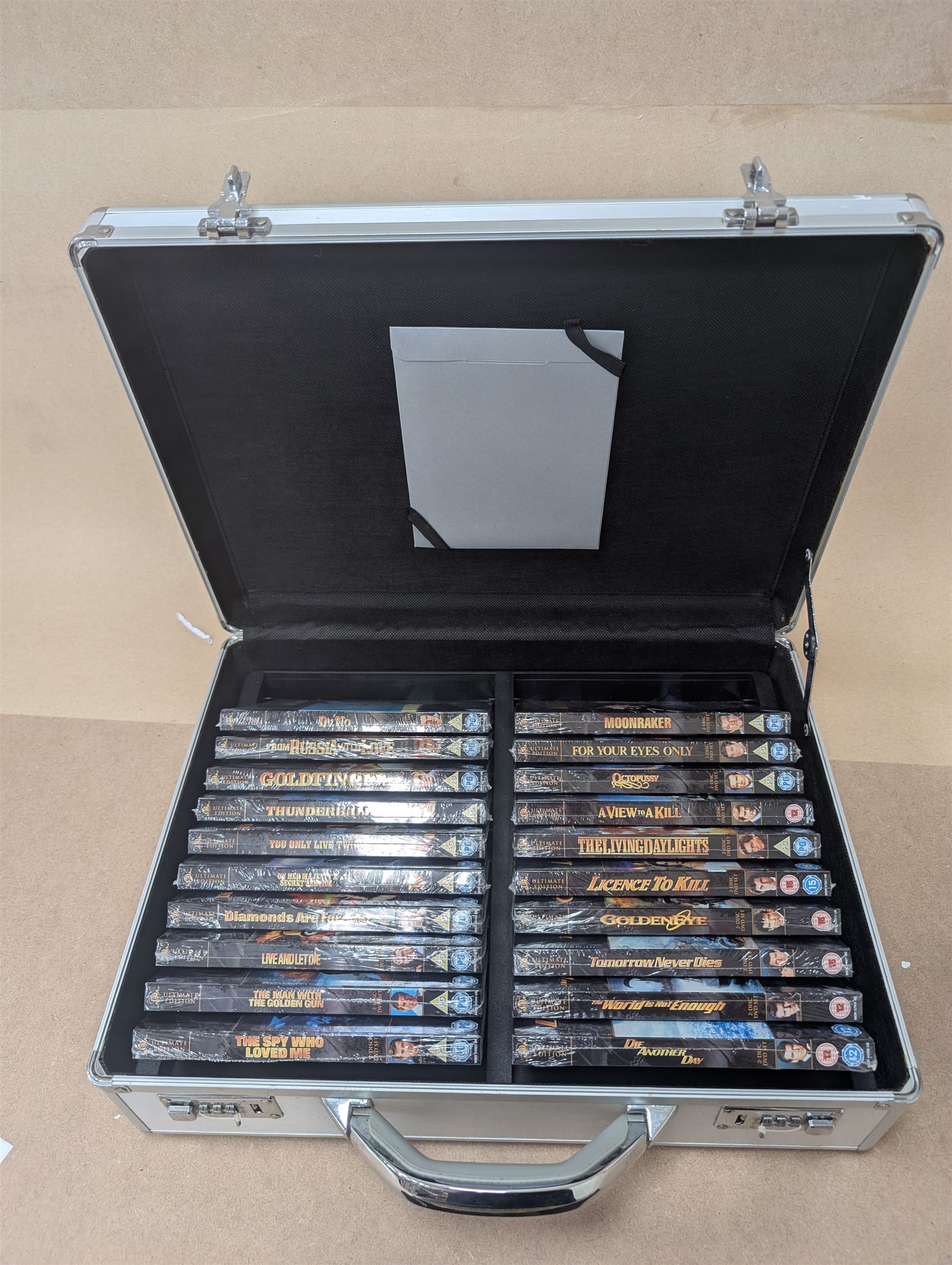 James Bond DVD collection, housed in a 007 collectors briefcase, together with Corgi The Definitive Bond Collection Film Canister 4 Piece Set CC99106, Corgi James Bond Space Shuttle CC04001 and a Vanguard RAC special limited edition diecast model set, all boxed