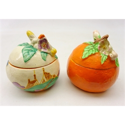  Clarice Cliff Newport Pottery Bizarre preserve pot and cover painted with houses and a tree and another in the form of an orange H10cm (2)  
