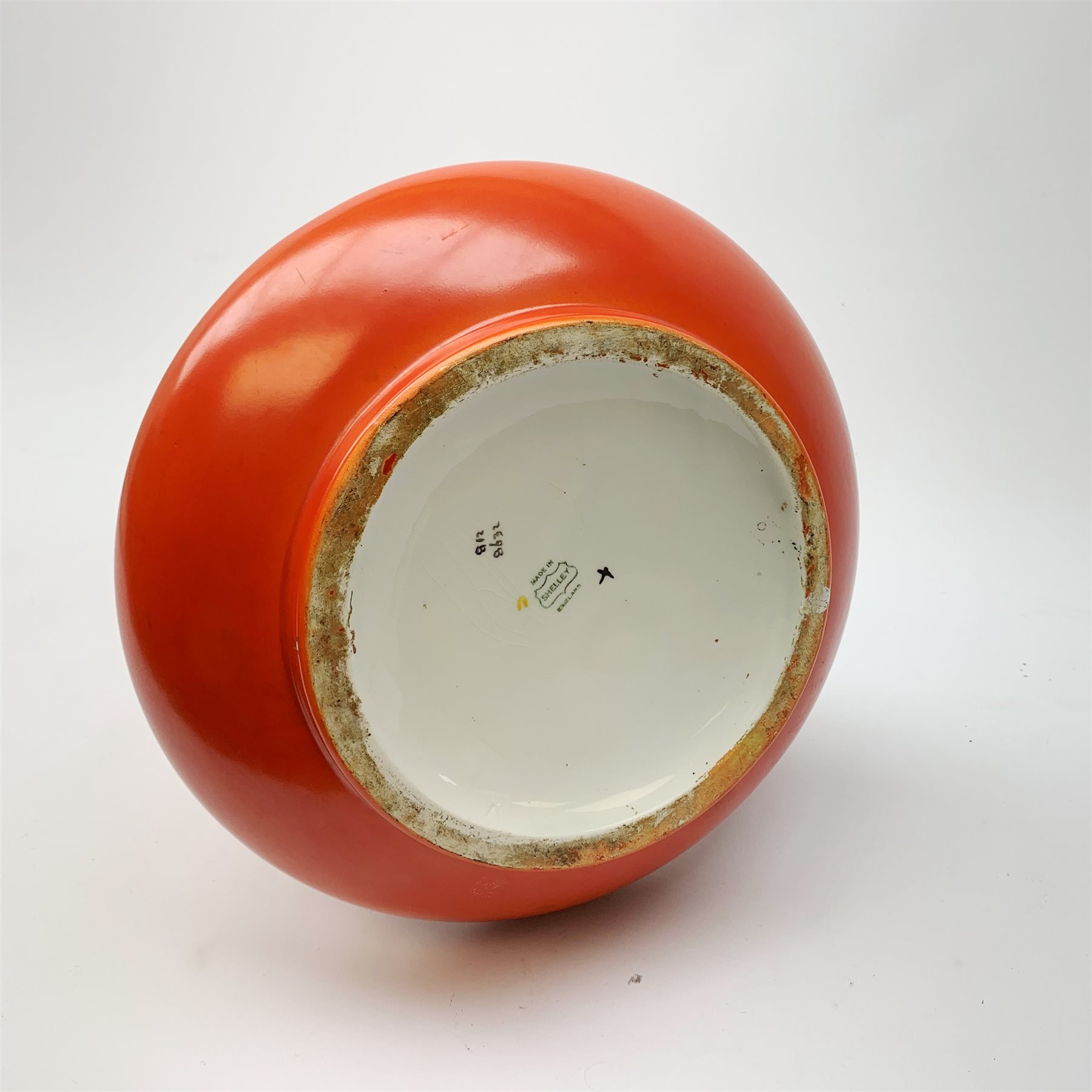 A large Shelley vase, of bulbous form with waisted neck and flared rim, the red ground decorated with the Vine and Grape pattern, with printed mark beneath and painted pattern no 8632, H41cm. 