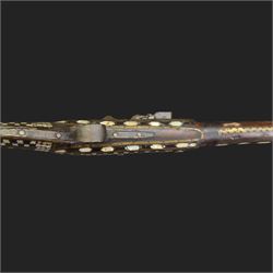 Indian Jezail style flintlock musket, with 118cm barrel, the East India Company lock marked 1818,  the curved butt inlaid with mother of pearl and brass decoration, overall L155cm