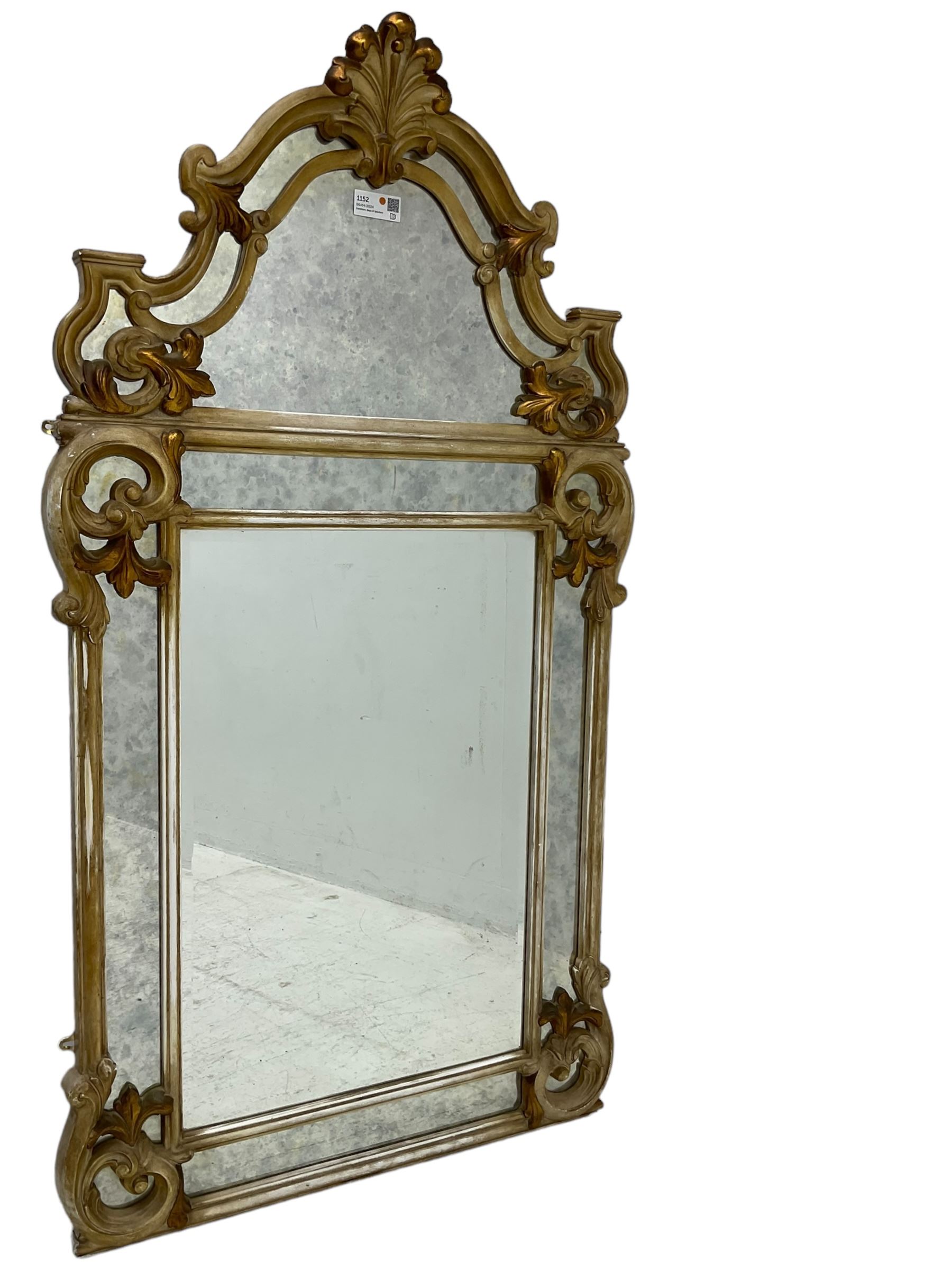 Victorian design parcel gilt wall mirror, shaped cresting with foliate cartouche pediment, decorated with C-scrolls and scrolled foliage, moulded frame with segmented mirror plates
