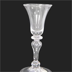 Mid 18th century wine glass, circa 1730-1740, with bell shaped bowl upon an inverted baluster stem with internal tear and basal knop, upon conical folded foot, H15cm