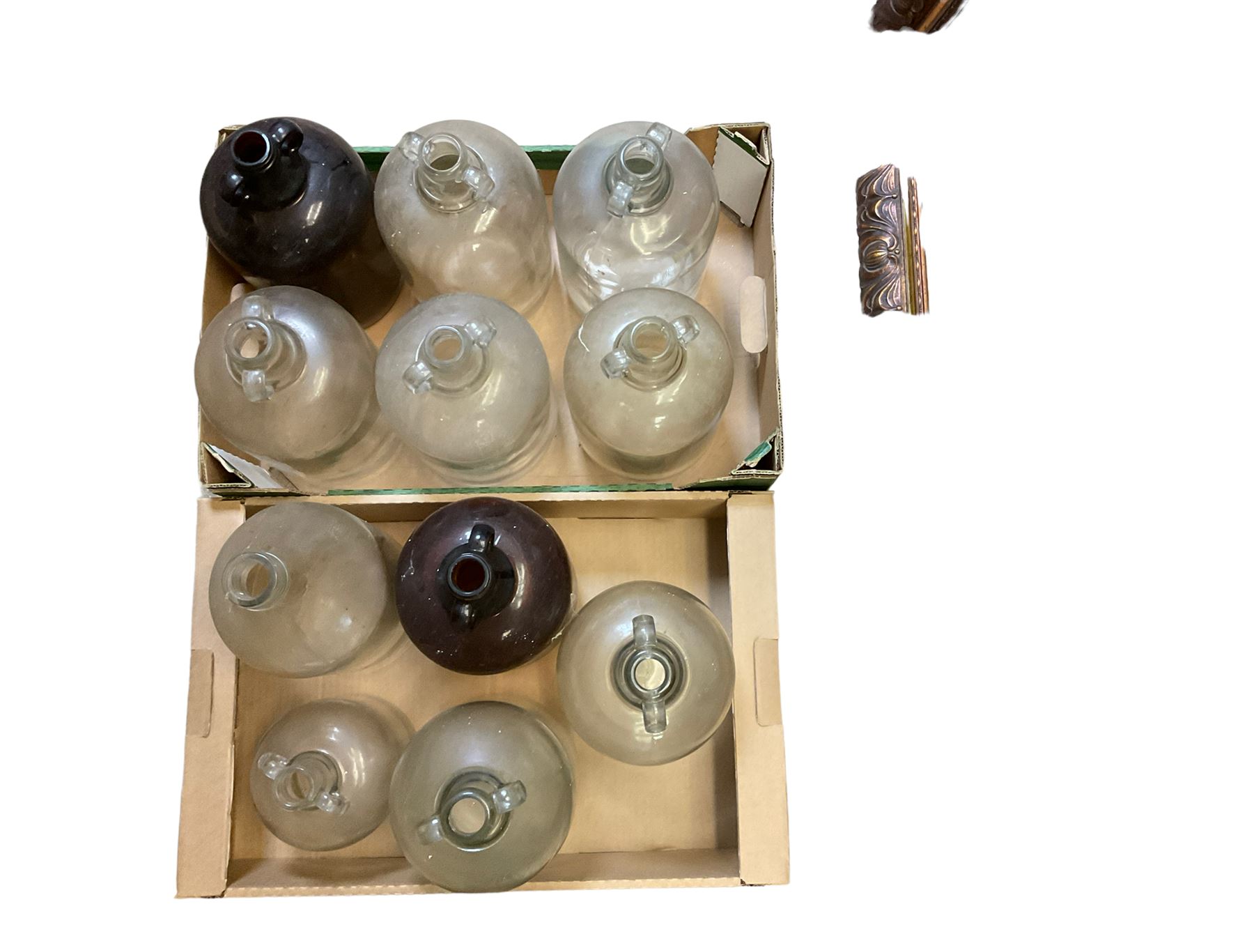 Eleven glass demijohns, including two brown glass examples