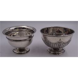 Silver sugar bowl, probably Edwardian, of circular form with repousse part fluting, upon circular stepped foot, hallmarks worn and indistinct, probably Sheffield 1901, H8cm D11.5cm, together with a later mid 20th century example, of plain footed circular form, hallmarked Robert Pringle & Sons, London 1950, H7.5cm D11cm, approximate total weight 6.13 ozt (190.7 grams)