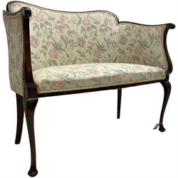 Early 20th century mahogany framed two seat salon settee, upholstered in floral pattern fabric, on cabriole supports