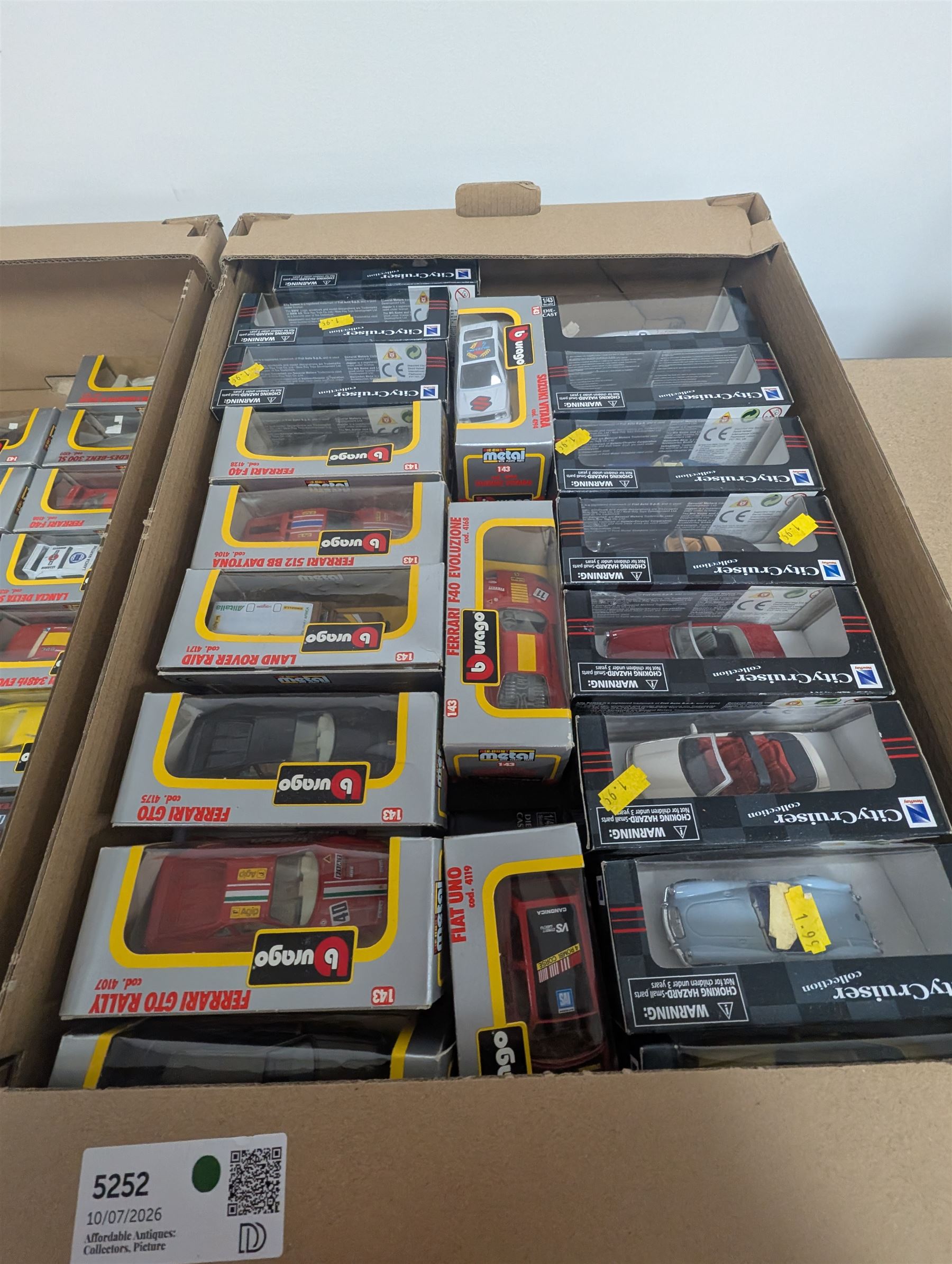 Collection of 1:43 scale diecast model vehicles, mostly Bburago, all boxed, in three boxes