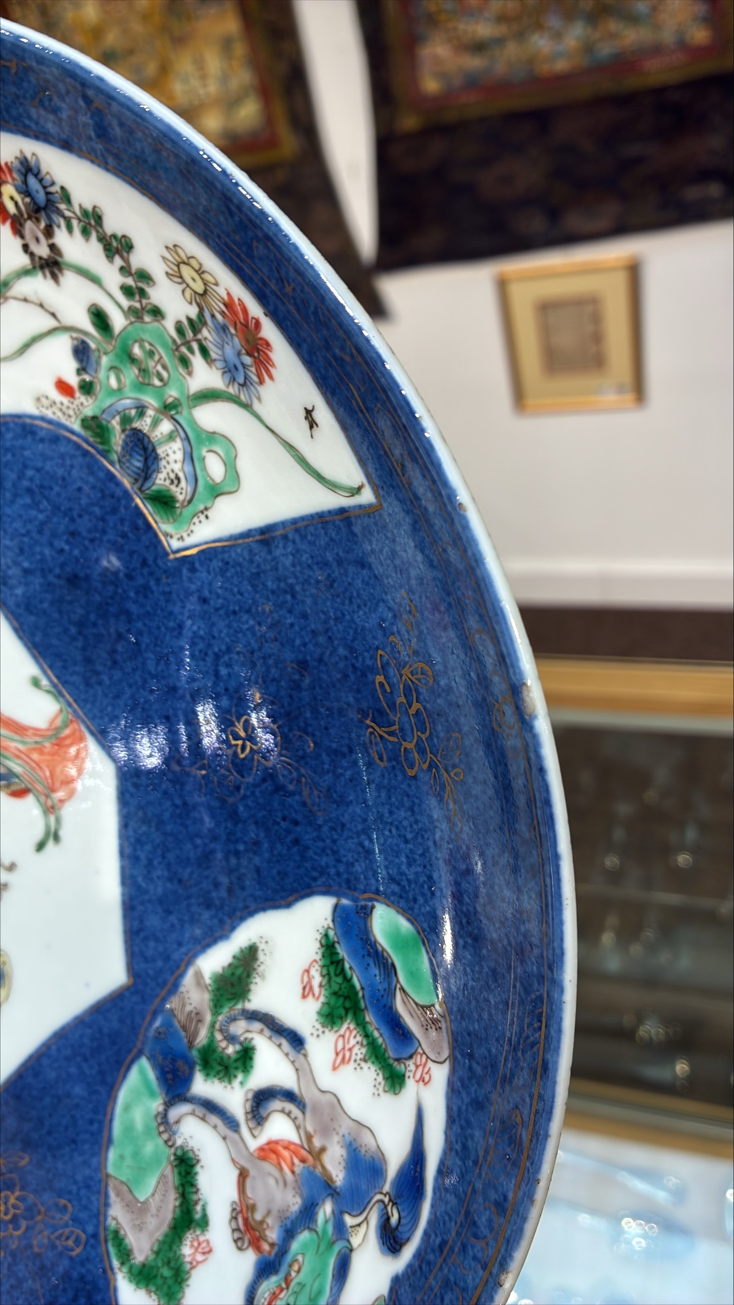 Chinese powder blue ground famille verte charger, possibly Kangxi, decorated with a central cartouche enclosing two female figures, with smaller shaped panels enclosing lions and foliage, square seal mark in blue to base, D28cm